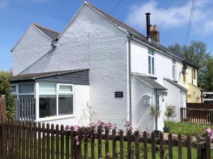 a white house with a fence in front of it at 2 Bed in St Helens oc-76608 in Brading