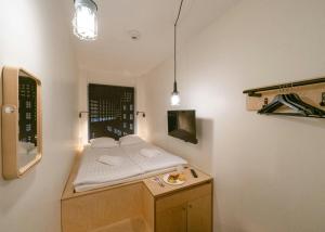a small room with a bed and a table at Forenom Hostel Jyväskylä in Jyväskylä +48 photos