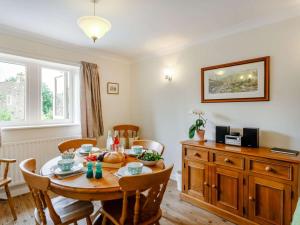 a dining room with a table and chairs and a kitchen at 2 Bed in Skipton oc-87598 in Kettlewell +7 photos