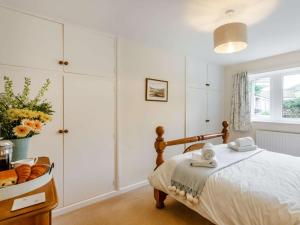 a white bedroom with a bed and a window at 2 Bed in Skipton oc-87598 in Kettlewell