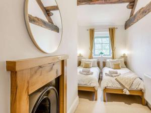 two twin beds in a room with a mirror at 3 Bed in Keighley oc-89528 in Haworth