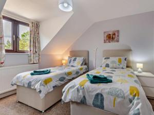 a bedroom with two beds and a window at 4 Bed in Wareham oc-77511 in Stoborough