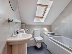 a bathroom with a sink and a toilet and a bath tub at 4 Bed in Wareham oc-77511 in Stoborough +25 photos