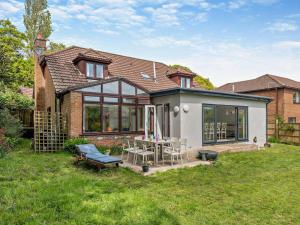 a house with a patio with a table and chairs at 4 Bed in Wareham oc-77511 in Stoborough