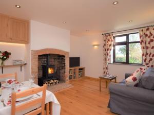 a living room with a couch and a fireplace at 1 Bed in Taunton oc-49569 in North Curry