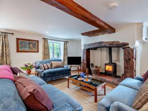 a living room with a blue couch and a fireplace at 3 Bed in Salisbury oc-95325 in Amesbury