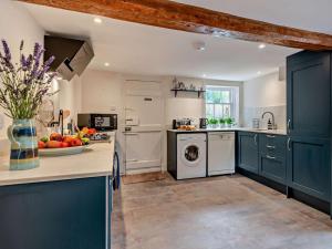 a kitchen with blue cabinets and a dishwasher at 3 Bed in Salisbury oc-95325 in Amesbury