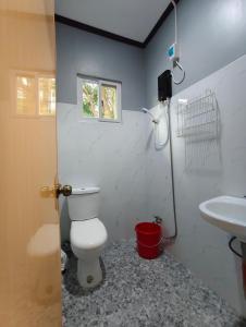 a bathroom with a toilet and a sink at Aquino Stays in Luna +36 photos