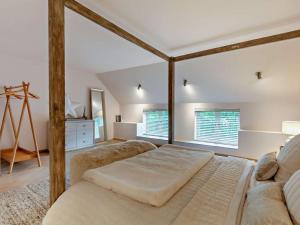 a bedroom with a large bed and a couch at 2 Bed in Knaresborough oc-95078 in Brompton
