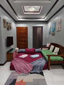 a bedroom with a bed and a desk in it at Aquino Stays in Luna