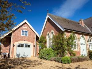 a red brick house with a white garage at 1 Bed in Ripon oc-95074 in Dishforth