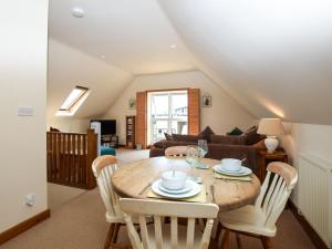 a dining room with a wooden table and chairs at 1 Bed in Southampton oc-92943 in Chalbury