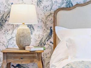 a lamp on a night stand next to a bed at 1 Bed in Southampton oc-92943 in Chalbury