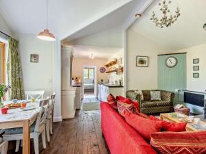 a living room with a red couch and a table at 3 Bed in Watchet oc-95161 in Washford
