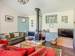 a living room with a couch and a fireplace at 3 Bed in Watchet oc-95161 in Washford