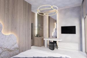 a bedroom with a bed and a chandelier at Theretra Pefki Center in Pefki