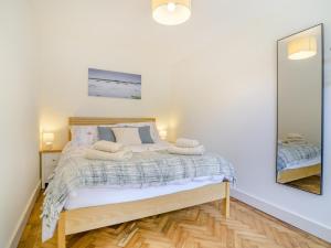 a bedroom with a bed and a mirror at 2 Bed in Weston-super-mare oc-94385 in Worle