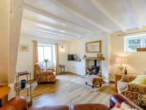 a living room with a couch and chairs and a fireplace at 2 Bed in Malton oc-78794 in Norton