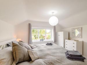 a bedroom with a large bed and a window at 2 Bed in Malton oc-78794 in Norton