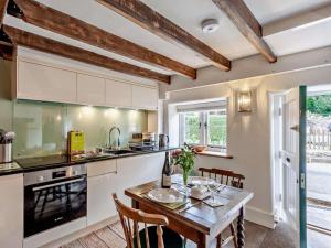 a kitchen with a wooden table with chairs and a dining room at 1 Bed in Bristol oc-95178 in Blagdon