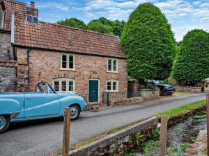 a blue car parked in front of a brick house at 1 Bed in Bristol oc-95178 in Blagdon
