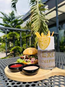 a tray with a sandwich and french fries on a table at FortExcel Hotels & Suites in Odogun