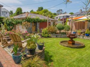 a backyard with a garden with a fountain at Bradleigh Lodge in St Austell +80 photos