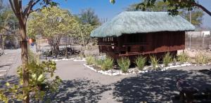 a small building with a grass roof at Cristy's Relaxing Sunny Place in Rimus