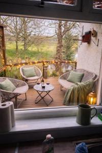 a view of a porch with chairs and a table at The Holm in Canonbie