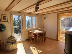 a dining room with a table and chairs and a window at Revier Schwettiberg Nr. 1 in Braunwald
