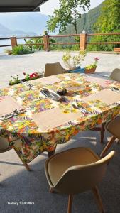 a table with a colorful table cloth on it at B&B Island View in Parzanica