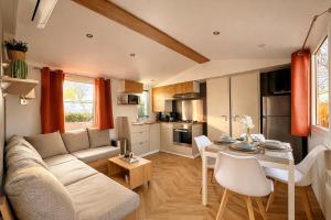 a living room with a couch and a table at Eden Cottages - Premium Cottage avec Piscine in Antibes