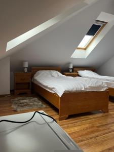 a bedroom with a bed and two windows at Conacul Maria in Ocna-Mureşului