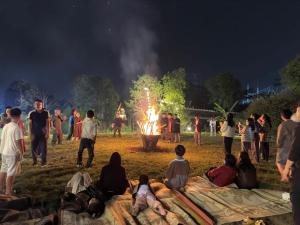 a crowd of people watching a fire show at night at Ume Villa & Retreat in Bóng Suối +86 photos