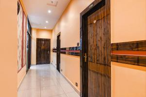 a corridor with a door in a building at FabHotel Royal Park Inn - Nr Eden Garden Stadium in Kolkata