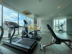 a gym with cardio equipment in a large room with windows at Spacious 2BR Condo with 2 Balconies in Sukhumvit16 in Bangkok