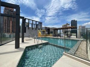 a swimming pool on top of a building at Spacious 2BR Condo with 2 Balconies in Sukhumvit16 in Bangkok
