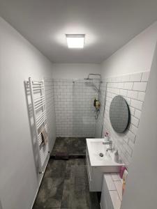 a white bathroom with a sink and a mirror at Central Studio Yoko , Craiova in Craiova +21 photos