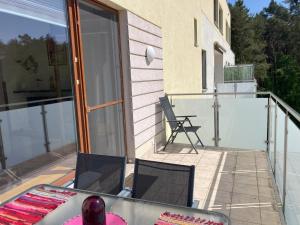 a patio with two chairs and a table on a balcony at Aquamarina Turkus Apartament 253 in Międzyzdroje