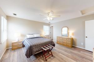 a bedroom with a bed and a ceiling fan at Rylander-Timmerman House OBX in Nags Head