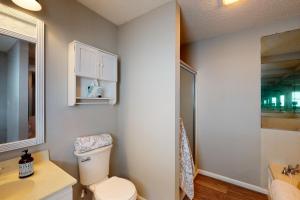 a bathroom with a toilet and a sink at Rylander-Timmerman House OBX in Nags Head +41 photos