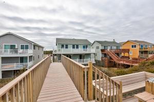 a wooden boardwalk leading to a row of houses at Rylander-Timmerman House OBX in Nags Head