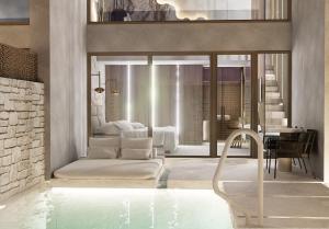 a hotel room with a pool and a bedroom at Theretra Pefki Center in Pefki