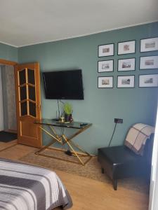 a bedroom with a bed and a table and a tv at Narva Apartments in Narva
