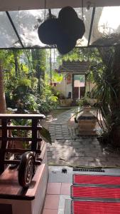 a garden with a bench and a room with plants at Fort flora in Cochin