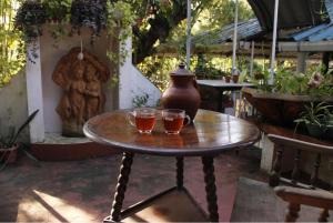 a table with two drinks on it with a vase on it at Fort flora in Cochin