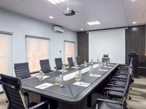 a large conference room with a long table and chairs at Peregrine Hotel Jos in Jos