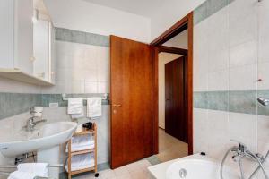 a bathroom with a sink and a toilet and a mirror at Residence La Brughiera Malpensa in Lonate Pozzolo +25 photos