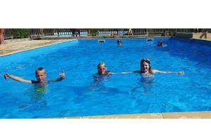 three children swimming in a swimming pool at Lodge Holidays - Les Sapins in Camurac +67 photos