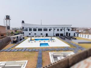 an aerial view of a building with a pool at Peregrine Hotel Jos in Jos